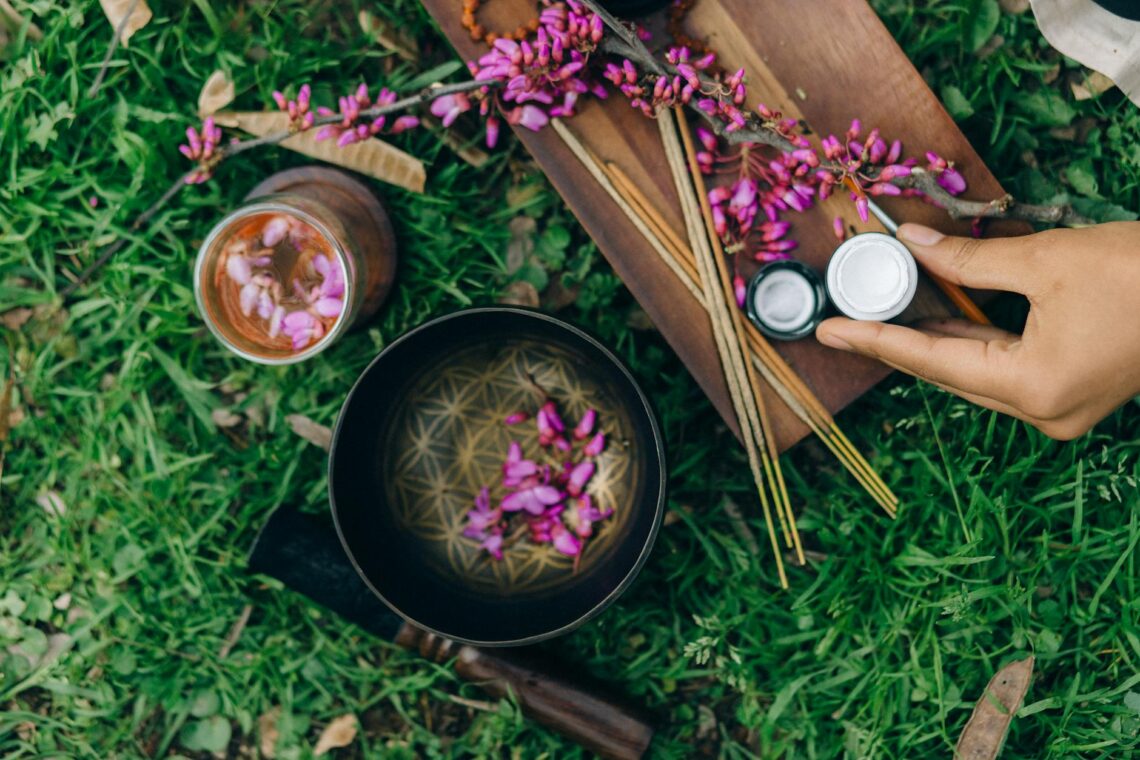 overhead photo of singing bowl and incense sticks