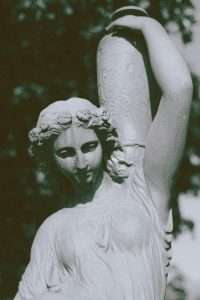 Ancient statue of woman with vase