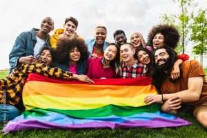 Happy diverse young friends celebrating gay pride festival - LGBTQ community concept