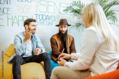 Homosexual couple during the psychological counseling with female psychologist in the modern office