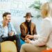 Homosexual couple during the psychological counseling with female psychologist in the modern office