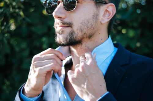 man in blue dress shirt and black formal suit